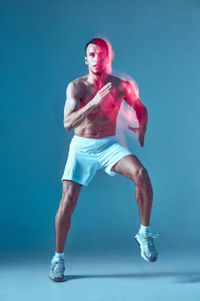 dancing-young-guy-with-naked-muscular-torso-performs-zumba-dance-neon-light-blurred-motion-sports