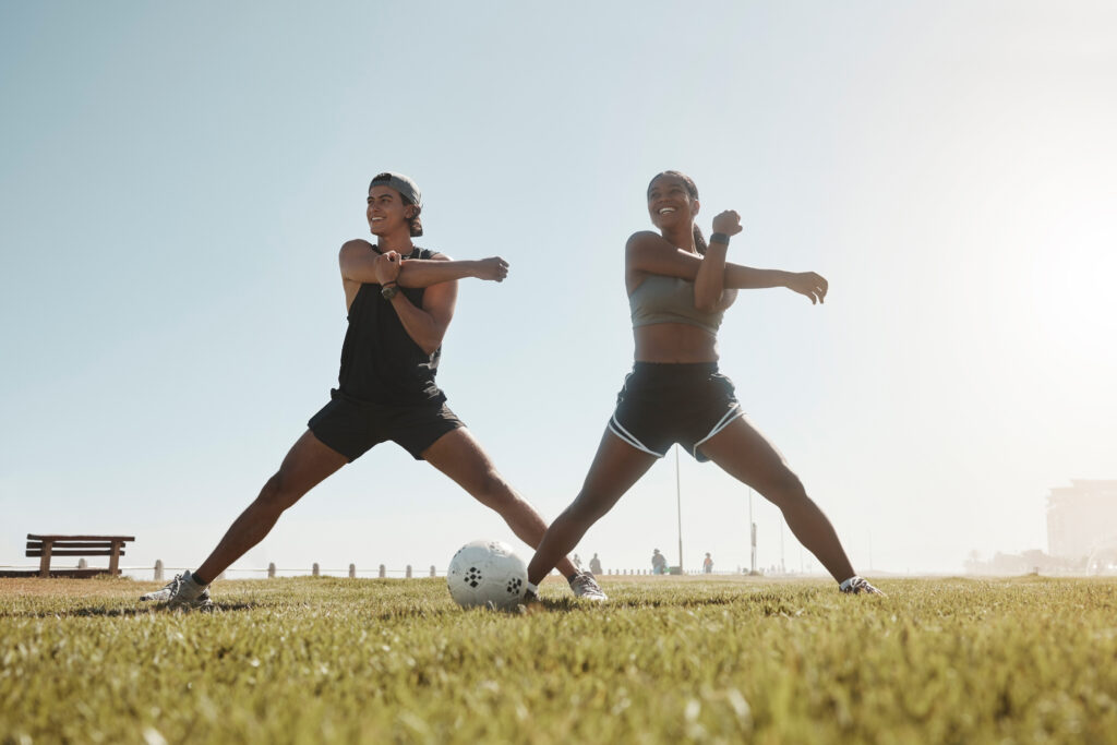 fitness-couple-arm-stretching-park-warm-up-outdoor-workout-football-training-sports-motivation-healthy-friend-athletes-doing-exercise-before-soccer-practice-nature