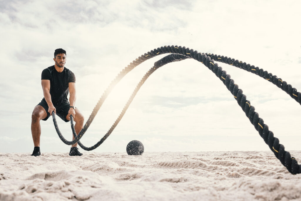 fitness-with-battle-rope-beach-endurance-challenge-strength-core-training-outdoor-exercise-sports-male-athlete-muscle-development-intense-performance-full-body-workout