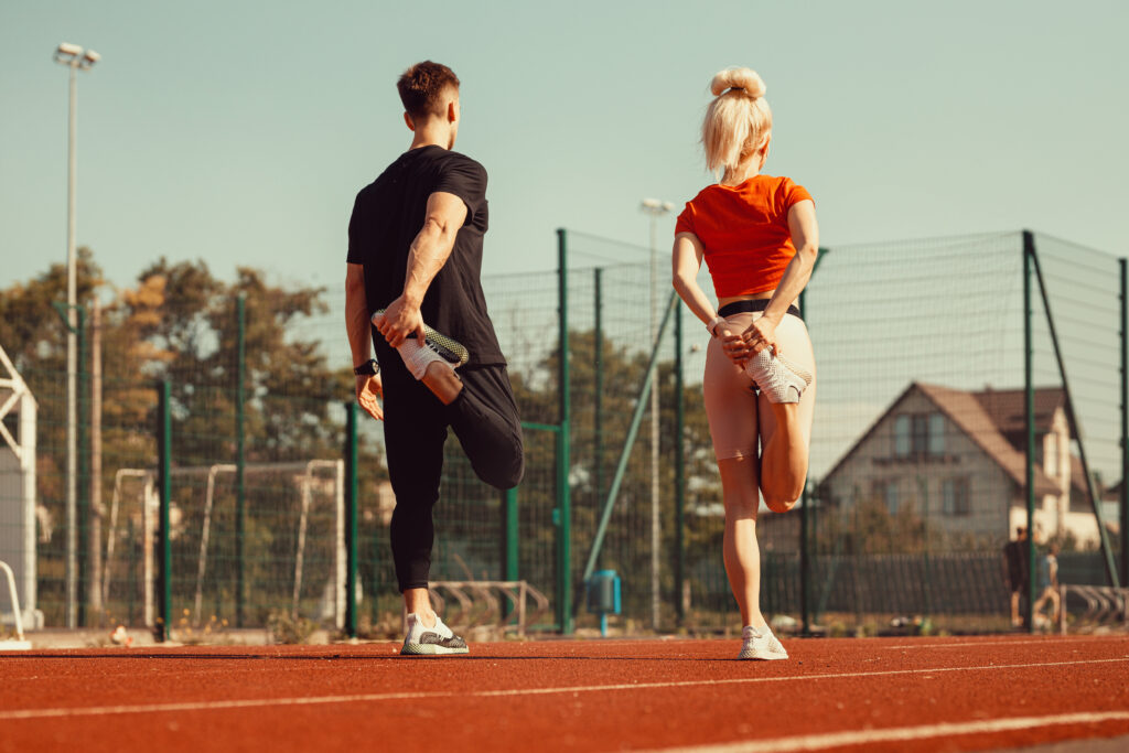 girl-guy-doing-warm-up-before-sports-exercises-school-stadium